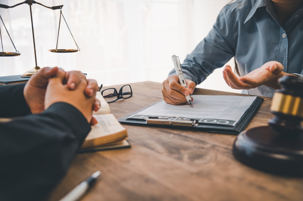 Lawyers advising a customer on judgment, agreements, and legal justice during a consultation.