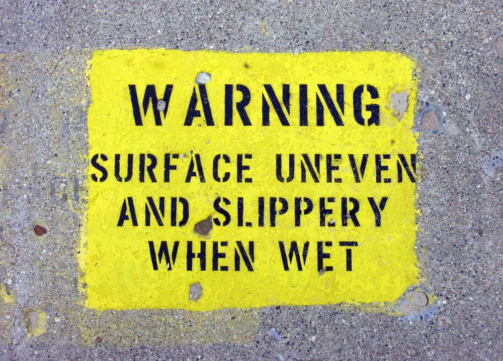 Slippery and uneven surface warning sign