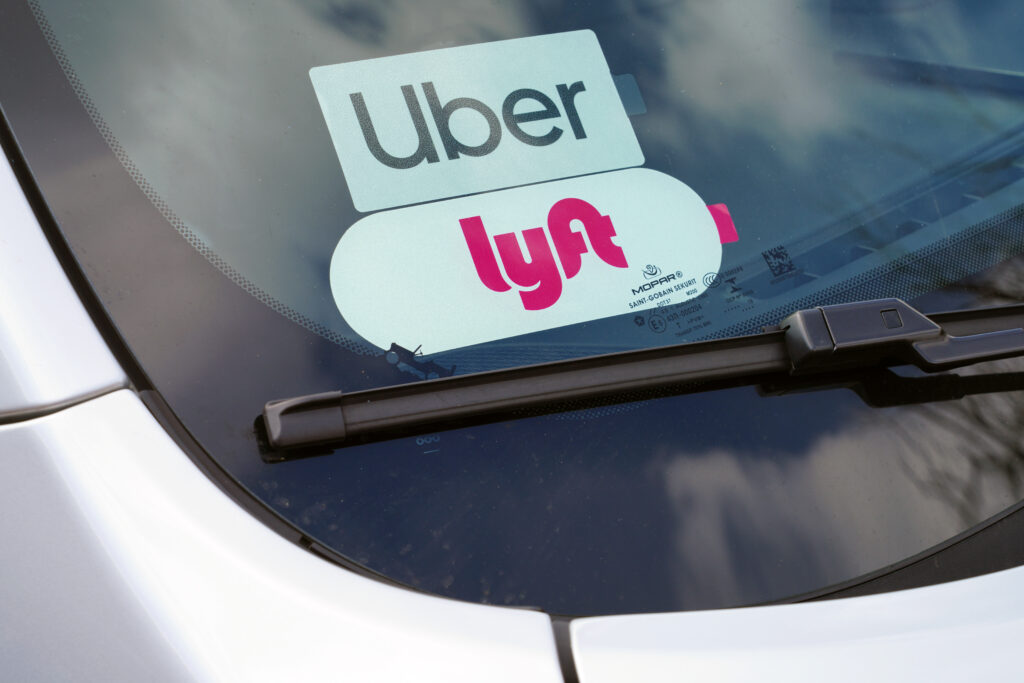 Uber & lyft sticker on the wind screen of a car