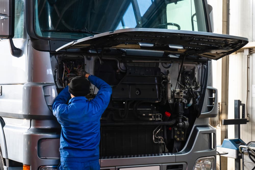 A mechanic performing truck maintenance at workshop