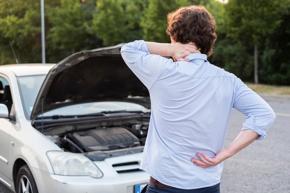 A man feeling back pain after the accident