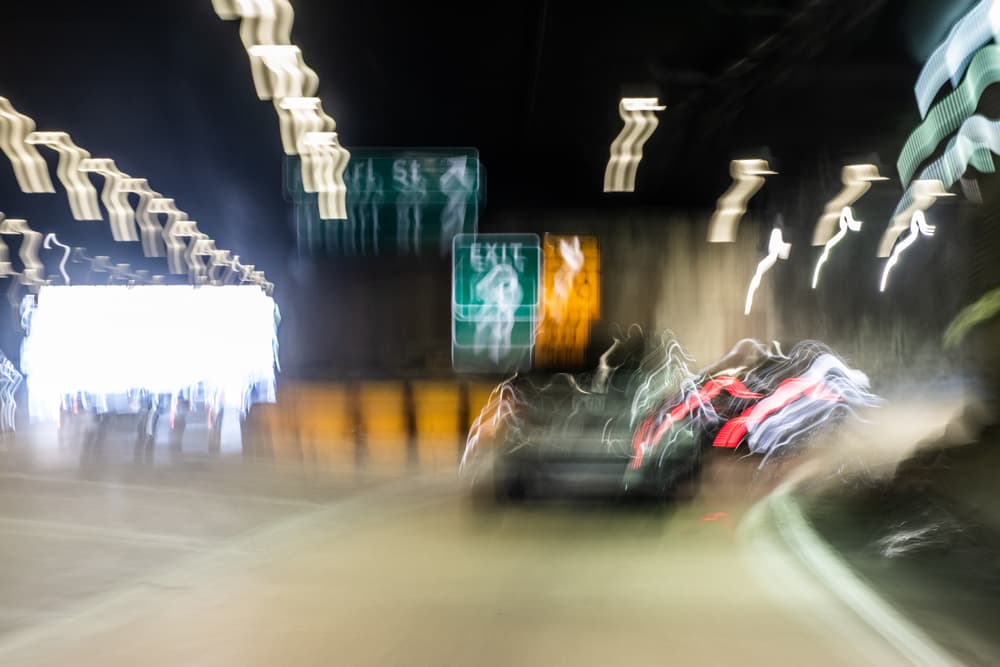 A blurry image showing impaired vision while driving a truck.